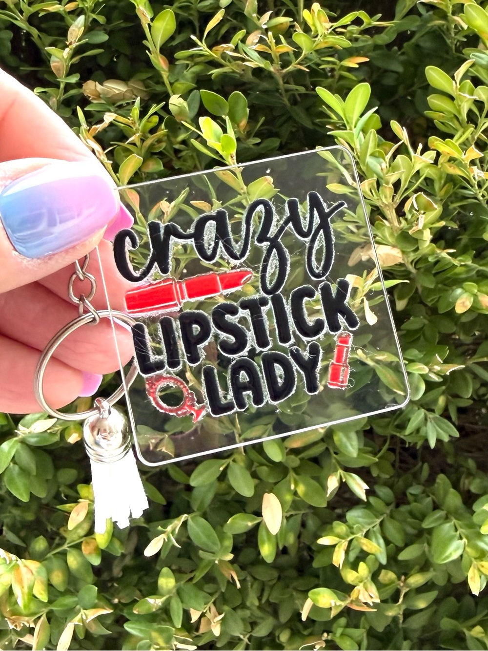 Hand Crafted clear lucite keychain beauty-themed with faux leather tassel